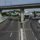 Motorists make their way through a partially deserted road after a complete lockdown was imposed by the state government in Chennai on May 24, 2021.